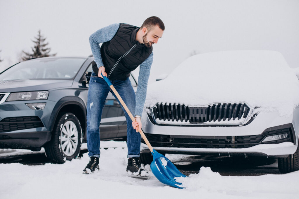 a guy, cleaning the snow before shipping his car from mississippi to Hawaii